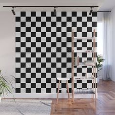 a black and white checkered wallpaper in an empty room with a wooden ladder