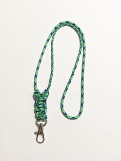 "Minimalist Paracord or Parachute Cord ID Lanyard I made this with a Multi-Colored parachute cord (Paracord 550) and it is knotted at the bottom by the id clip. The ends are melted into the back of the knots. The Overall Length of the Lanyard is about 18\". (From the back of the neck to the end of the Lobster Claw ID clip) Paracord 550 is: 4mm in diameter 7 inner strands Polyester Choose the break away option for the pull apart plastic clasp to be added to the back of the neck area of the lanyar Purple Camouflage, Blue Minimalist, Id Lanyard, Parachute Cord, Lobster Claws, 550 Paracord, Pull Apart, Enamel Charms, Badge Holders Lanyard