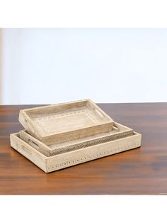 two wooden trays sitting on top of a wooden table