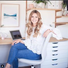 a woman sitting at a desk with a laptop