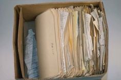 an open file box filled with lots of papers