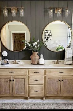 a bathroom with two round mirrors above the sinks