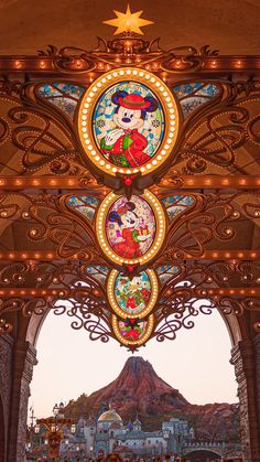 the entrance to disney's hollywood studios is decorated with beautiful stained glass and lights