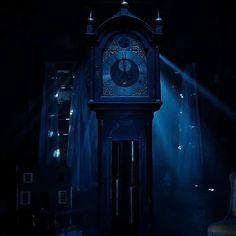 an old clock in the dark with light coming from behind it