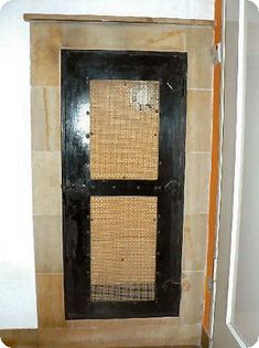 an old fashioned door in the corner of a room with tile walls and flooring