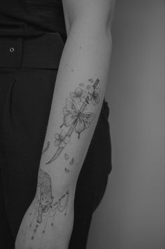 a person with a flower tattoo on their arm