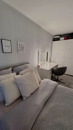 a bedroom with a bed, desk and chair in the corner next to an office