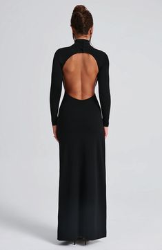 Say hello to Imelda, your new fave black dress to wear everywhere. This super sexy, versatile maxi is cut with sleek long sleeves, high neck and eye-catching low open back. It's finished with a thigh high split and boning for added structure. Style yours with black mule heels and a chic hair up. 



Colour: Black.

Premium stretch crepe fabric.

Fully lined. High neck with buttons on back neck.

Long fitted sleeves.

Boning on side for added structure.

Moulds to figure with bodycon fit.

Thigh Long Sleek Dress, Long Sleeve Dress Open Back, Black Dress Long Sleeve Outfit, Backless Dress Long Sleeve, Black High Neck Dress, Black Dress With Open Back, Bare Back Dress, High Neck Black Dress, Homecoming Dresses Corset