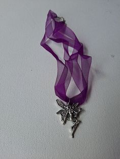 A 1.5" x 1" pewter one-sided dancing faerie/fairy pendant on a 16" x .5" x .01"  double strand purple ribbon choker with ring spring clasp setting. Hand-made. As is, no returns. Each creation varies slightly different than each other but photos pretty much depict condition, details, and description as each hand creation is made with the same materials. See photos for condition, details, and visual description. Ribbon Choker, Fairy Pendant, Purple Ribbon, Necklace Lengths, Choker Necklace, Violet, Hand Made, Bathing Beauties, Jewelry Necklaces