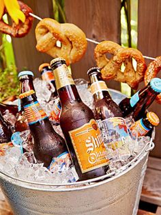 beer and pretzels are sitting in an ice bucket