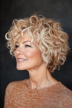 Click for More ➡️ | Save for Later ❤️  This pixie-bob hybrid features short, bouncy curls that fall just below the ears. The sunlit blonde color, a soft blend of light blonde and golden hues, brings a fresh, radiant feel to the cut, making it a standout choice for 2024. (Sunlit Blonde Curly Pixie-Bob - Short Curly Hairstyles For Women Over 50) Short Curly Hair Styles For Women Over 50 Perms, Short Curly Bob Hairstyles Over 50, Short Layered Curly Blonde Hair, Short Curly Blonde Hair Natural, Curly Layered Bob With Bangs, Short Blonde Hairstyle Women, Blonde Curly Hair Highlights, Curly Short Blonde Hair, Short Curls Hairstyles