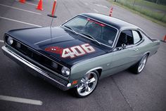 an old muscle car with the number 40 on it's hood parked in a parking lot