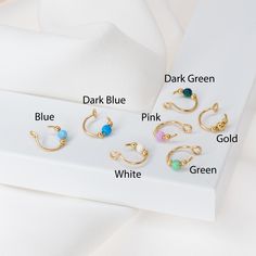 six pairs of gold nose rings with different colors