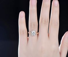 a woman's hand with a diamond ring on it