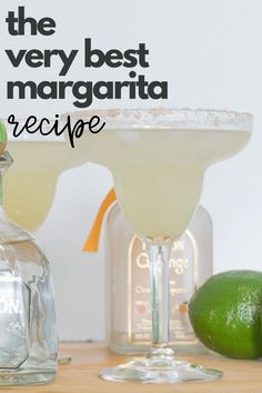 the very best margarita recipe is in front of two glasses with limes next to it