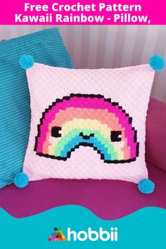 a crocheted pillow with a rainbow on it