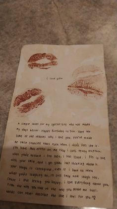 a piece of paper with writing on it and two red lipstick imprints next to each other