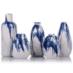 five blue and white vases sitting next to each other