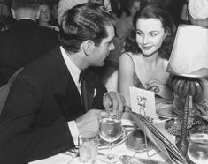 a man and woman sitting at a dinner table