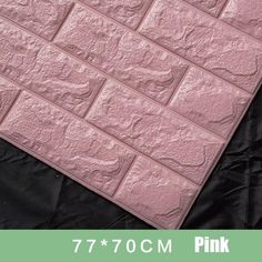 a pink brick wall is shown with black fabric on the bottom and bottom part, which has