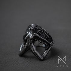 If a ring looks like it was made by a devil, it's called a "devil girl ring". A stylized picture of a devil girl is often found on this ring. It has wings and other devilish features. With careful attention to detail, this accessory gives off a rebellious and daring vibe, making it a statement piece for people who like to dress in a bold and unique way. This devil girl ring is a one-of-a-kind accessory that adds a touch of rebellious style to any outfit. It's an eye-catching piece of jewelry for Gothic Wedding Rings, Devil Girl, Gothic Ring, Geek Jewelry, Gothic Rings, Paper Stars, Rose Quartz Gemstone, Tree Of Life Pendant, Creating Jewelry