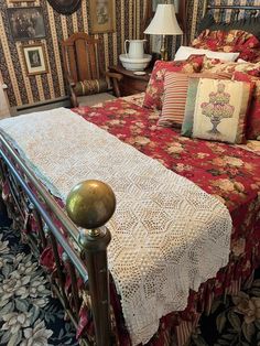 a bed with red and white bedspread in a bedroom