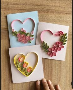 three handmade greeting cards with flowers and hearts