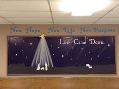 a bulletin board with the words love came down and a nativity scene on it