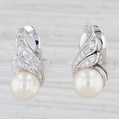 Gemstone Information: - Cultured Pearls - Size - 9 mm  Cut - Round Bead Shape Color - White - Natural Diamonds - Total Carats - 0.30ctw Cut - Round Brilliant Color - G - I Clarity - VS2 Metal: 14k White Gold Weight: 8.2 Grams  Stamps: K14, 560 Plat Closure: Clip On Non Pierced Measurements: 20.2 x 10.3 mm Each piece is thoroughly examined and refinished as needed by our professional jewelers, graded by our in-house GIA (Gemological Institute of America) Graduate Gemologist, and inspected for quality before being carefully packaged and promptly shipped. [SKU: A7037] phd Anniversary White Diamond Clip-on Earrings, Classic Formal Pearl Earrings With Pave Setting, Formal White Gold Clip-on Fine Jewelry Earrings, Classic White Gold Clip-on Earrings For Anniversary, White Round Clip-on Diamond Earrings, Diamond White Gold Clip-on Earrings For Anniversary, Elegant Formal Pearl Earrings With Pave Setting, Elegant Diamond White Pearl Earrings With Pave Setting, Elegant Diamond White Clip-on Jewelry