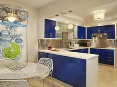 a kitchen with blue cabinets and white counter tops