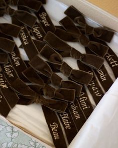 a box filled with lots of brown bow ties