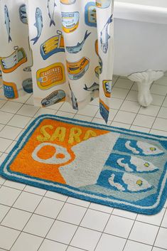 a bathroom with a bathtub, rug and shower curtain