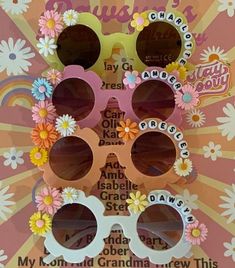 the sunglasses are made out of paper and have flower decorations on each pair, along with words that spell out their names