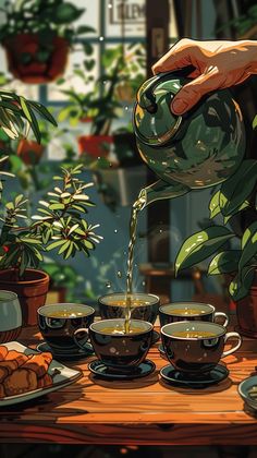 a person pours tea into cups on a table with potted plants in the background