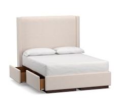 a white bed with two drawers underneath it