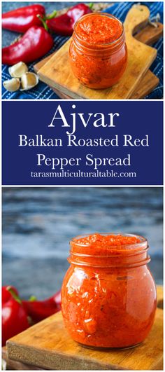 a jar filled with red pepper spread sitting on top of a cutting board