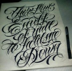 a drawing with some type of lettering on top of it and a pen in the bottom right corner