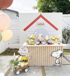 a charlie the snoopy birthday party with balloons and decorations on display in front of a house