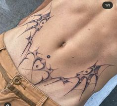 a close up of a person's stomach with an abstract tattoo design on it