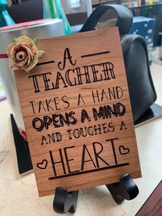 a wooden sign that says teacher takes a hand opens a mind and touches a heart