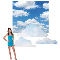 a woman in a blue dress standing next to an image of the sky and clouds