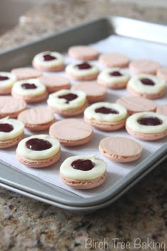 cookies with jam in the middle on a cookie sheet ready to go into the oven