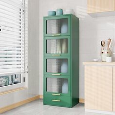 a tall green cabinet with glass doors in a kitchen