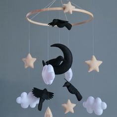 a mobile with stars, moon and cat on it