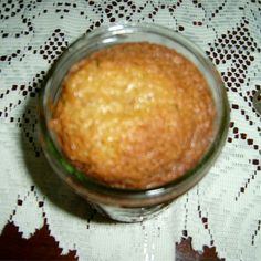 a glass jar filled with food sitting on top of a white table covered in lace