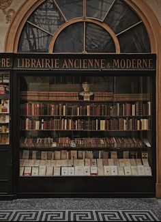 an old book store with many books on it's shelves and the doors open