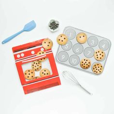 cookie cookies are placed in the shape of an oven and baking utensils next to it