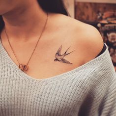 a woman with a bird tattoo on her chest