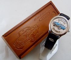 Fossil made Relic 1957 Chevy convertible vintage wristwatch. Classic Fossil design from their collectibles era. The face features a raised 3D detailed 1957 Chevrolet convertible in blue and silver tone with white sidewalls. Released by Fossil in the 90s as part of their Classic American Cars series. Black cowhide leather band with man made backing. Comes in a matching slide open wood box. Sold out novelty collectible wristwatch in excellent working condition. Watch case diameter 36 mm. Band widt Chevy Convertible, Bronco Horse, Chevrolet Car, 1957 Chevy, Disney Artists, 1957 Chevrolet, Series Black, American Cars, Wood Box