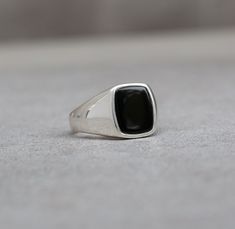 This meticulously crafted signet, featuring a polished cushion-shaped black onyx, combines the timeless appeal of vintage aesthetics  with a sleek modern design, making it an ideal and thoughtful gift for you or your loved one. Great as an Gift for a Men, Musician, Guitarist, Skater or Modern Fashion enthusiast High polished outside and inside Available in all sizes Ring from the picture is : 10US size Top Plate : 14x12mm Onyx : 12x10mm Side thickness: 2mm Bottom thickness ~ 1.8mm Side and botto Modern Black Enamel Signet Ring For Anniversary, Modern Black Signet Ring With Polished Edges, Black Rings With Polished Edges For Gifts, Black Jewelry With Polished Edges For Gift, Modern Black Sterling Silver Signet Ring, Black Sterling Silver Rectangular Signet Ring, Classic Black Enamel Signet Ring As Gift, Black Signet Ring With Polished Finish Gift, Modern Mens Rings